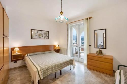 a bedroom with a bed and a large window at Il Poggio di Poiolo in San Bartolomeo al Mare