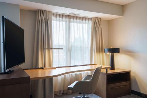 a hotel room with a desk and a window at Residence Inn Columbia MD in Ellicott City