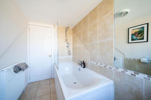 a bathroom with a white sink and a shower at Seaside Home in Stonehaven, Aberdeenshire in Stonehaven