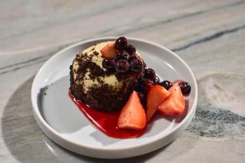 a piece of cake with fruit on a white plate at Washington Marriott Georgetown in Washington
