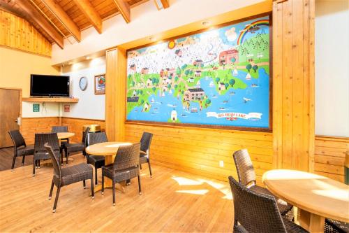 a classroom with tables and chairs and a large mural at Lagonita Lodge in Big Bear Lake