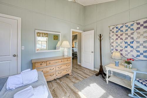 a bedroom with a bed and a dresser and a mirror at Cottage at the Lake in Moneta