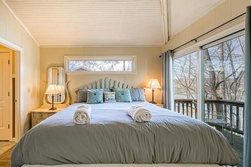 a bedroom with a large bed with towels on it at Cottage at the Lake in Moneta
