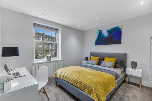 a bedroom with a bed and a desk and a window at Private and Luxury Apartment in Central London in London