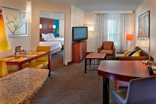 a hotel room with a bed and a living room at Residence Inn by Marriott Waldorf in Waldorf