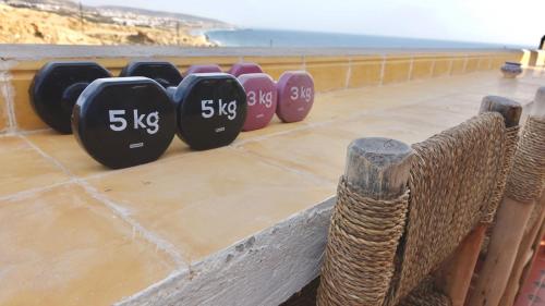 a row of clocks sitting on top of a wall at Cozy Surf House in Taghazout