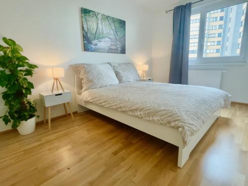 a bedroom with a bed and a potted plant at 55m2 Modern Flat with Balcony in Vienna