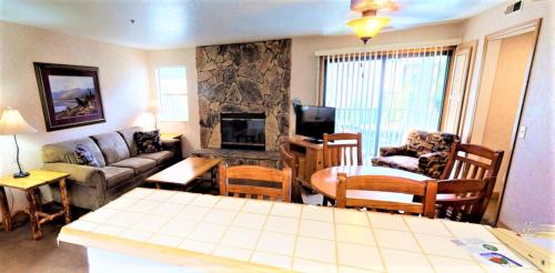 a living room with a couch and a fireplace at Lagonita Lodge in Big Bear Lake