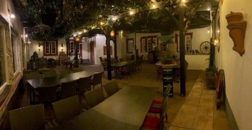 an empty restaurant with tables and chairs and lights at Hotel Rheingraf in Kamp-Bornhofen