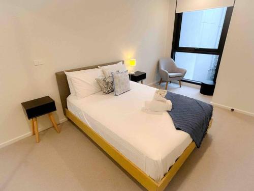 a bedroom with a bed with a teddy bear on it at Moonee Ponds Living on Young - 205 in Melbourne