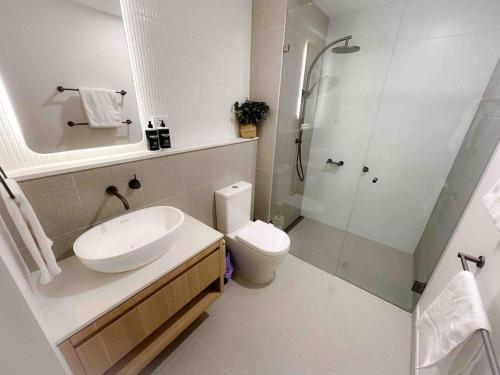 a bathroom with a sink and a toilet and a shower at Moonee Ponds Living on Young - 205 in Melbourne