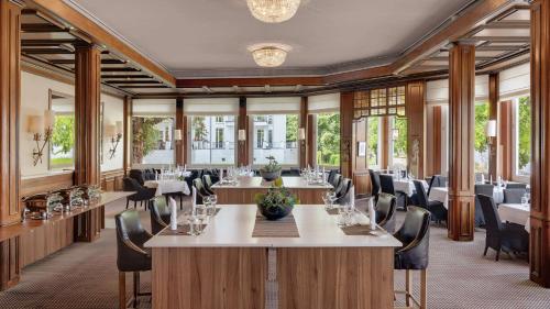 a conference room with tables and chairs and windows at Rheinhotel Dreesen in Bonn