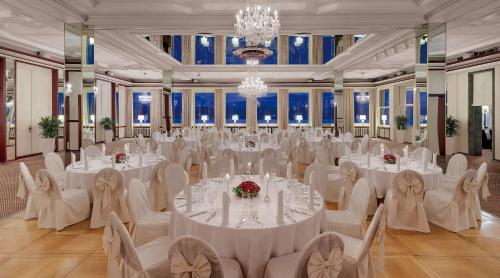 a large banquet hall with white tables and chairs at Rheinhotel Dreesen in Bonn