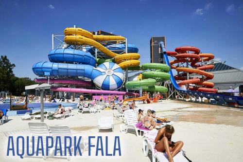 um parque aquático com escorrega aquático na praia em Lodz4u - Premium Apartments - MANUFAKTURA - Garaż - Wakacje 2024 em Lódź