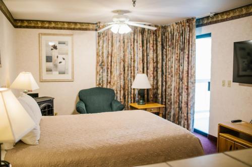 a hotel room with a bed and a chair at Friday Harbor Suites in Friday Harbor