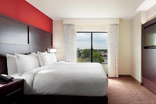 a hotel room with a large bed and a window at Residence Inn by Marriott Columbus OSU in Columbus