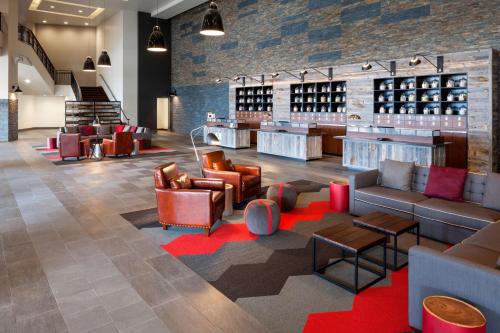 a wine tasting room with couches and tables at Four Points by Sheraton Seattle Airport South in SeaTac