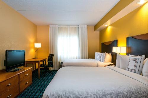 a hotel room with two beds and a television at Fairfield Inn & Suites by Marriott Nashville at Opryland in Nashville