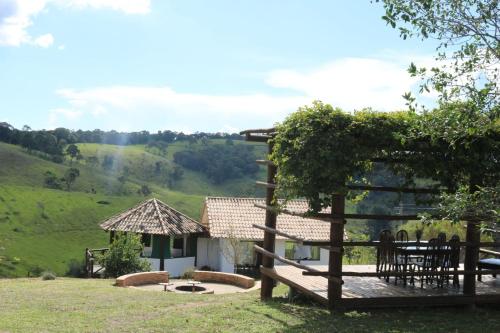 a view from the garden of a house with a bench at Estalagem Sensações in Cunha