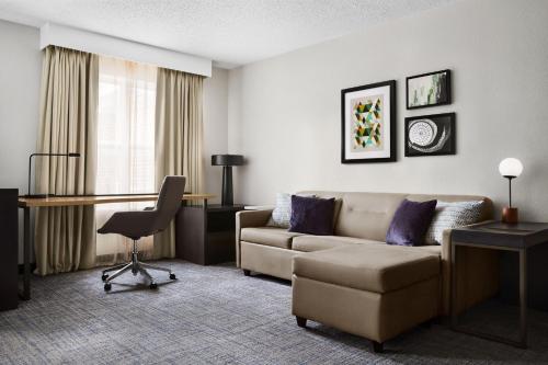 a living room with a couch and a desk at Residence Inn by Marriott Harrisburg Carlisle in Carlisle