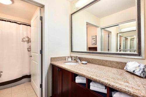 a bathroom with a sink and a large mirror at Residence Inn by Marriott Greensboro Airport in Greensboro