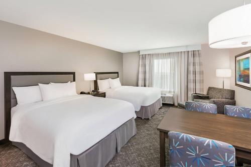 a hotel room with two beds and a desk at TownePlace Suites by Marriott Austin Northwest The Domain Area in Austin