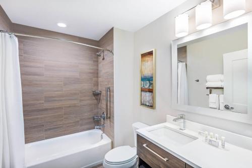 a bathroom with a sink and a tub and a toilet at TownePlace Suites by Marriott Austin Northwest The Domain Area in Austin