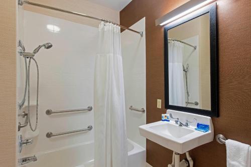 a bathroom with a shower and a sink and a shower at Fairfield Inn & Suites by Marriott Bloomington in Bloomington