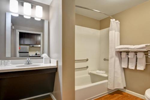 a bathroom with a sink and a tub and a toilet at TownePlace Suites by Marriott Alexandria in Alexandria
