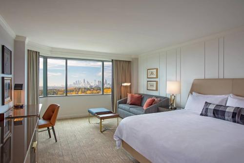 a hotel room with a bed and a couch at JW Marriott Atlanta Buckhead in Atlanta