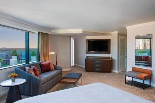 a living room with a couch and a flat screen tv at JW Marriott Atlanta Buckhead in Atlanta