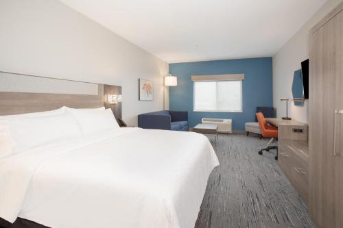 a hotel room with a white bed and a desk at Holiday Inn Express Hotel & Suites Idaho Falls, an IHG Hotel in Idaho Falls