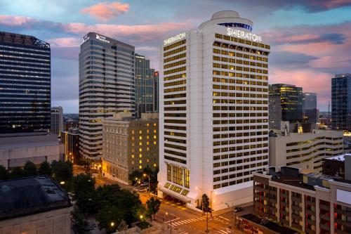 a tall white building in a city at night at Sheraton Grand Nashville Downtown in Nashville