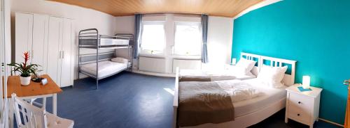 a bedroom with a bed and a bunk bed at Pension ZUM LINDENWALD Colbitz in Kolbitz
