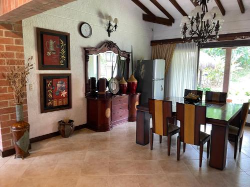 a kitchen with a table and a dining room at Finca hotel Villa Camila in Copacabana