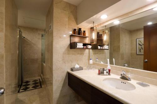 a bathroom with a sink and a shower and a mirror at Villahermosa Marriott Hotel in Villahermosa