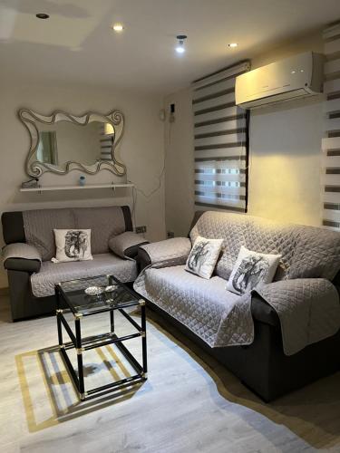 a living room with a couch and a table at Preciosa casa soleada en mirador albaicin in Granada