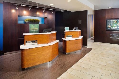a lobby with a reception desk in a building at Courtyard Houston Westchase in Houston