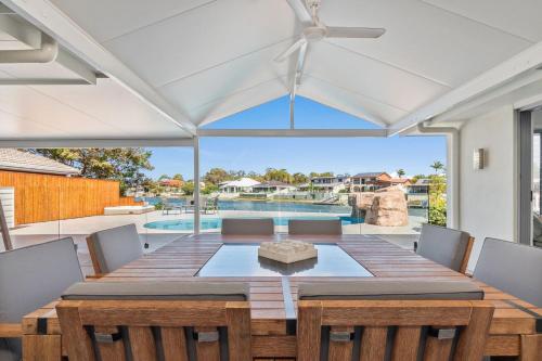 a dining room with a table and chairs and a pool at Pay for 3 nights, get 4th night for free in March in Maroochydore