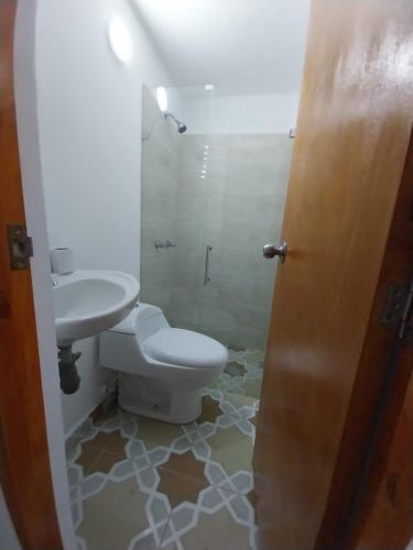 a bathroom with a toilet and a sink at Los balcones l in Medellín