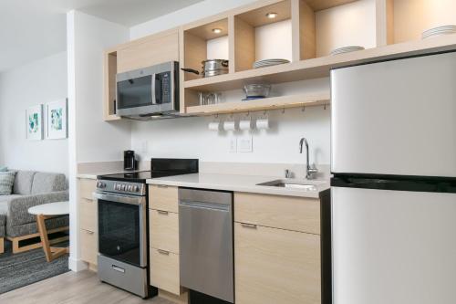 a kitchen with a sink and a stove top oven at TownePlace Suites by Marriott Oconomowoc in Oconomowoc