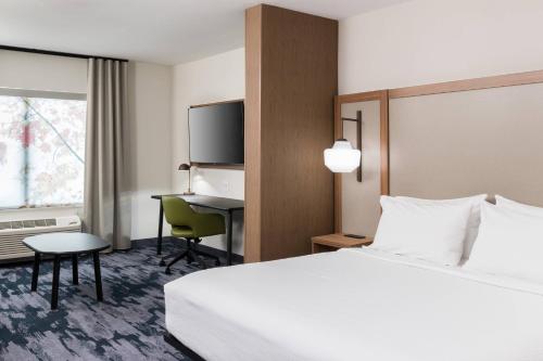 a hotel room with a bed and a desk at Fairfield Inn & Suites by Marriott Savannah I-95 North in Port Wentworth