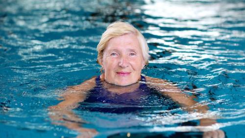 a woman in the water in a swimming pool at Colonial Inn Ellsworth in Ellsworth