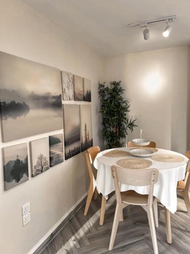 a dining room with a table and some pictures on the wall at The Farm Chalet in Al Ain