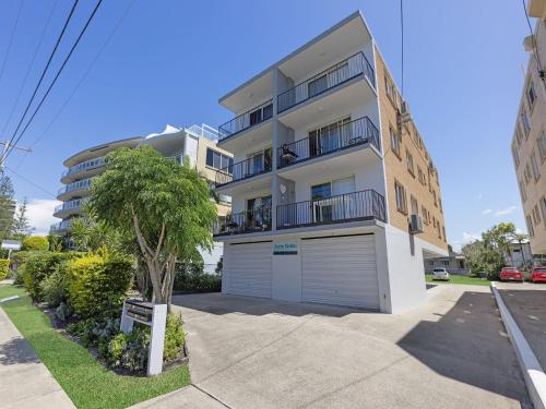 a large white building with a garage at Clayton Garden Unit 5 Golden Beach in Golden Beach