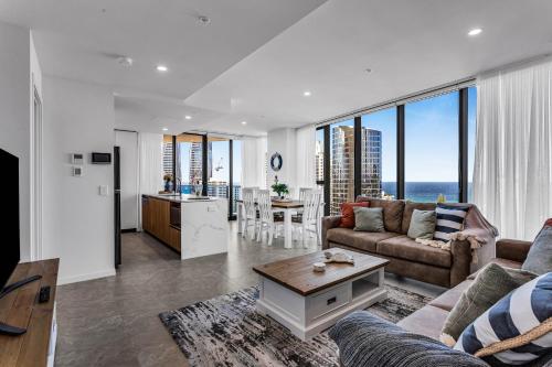 a living room with a couch and a table at The Gallery Residences Broadbeach in Gold Coast