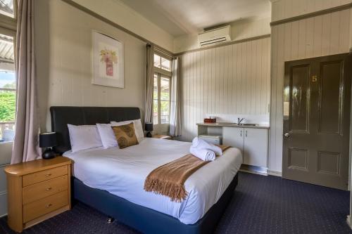 a bedroom with a large bed and a window at Yandina Hotel in Yandina