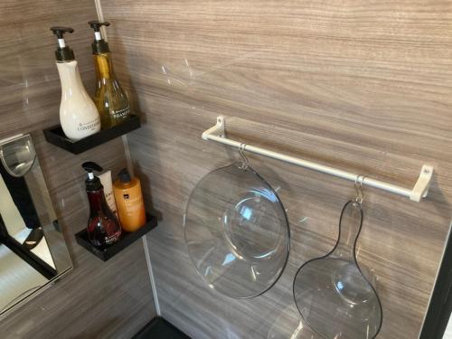 a bathroom with a glass bowl and bottles on a wall at HOKULANI by the sea - Vacation STAY 68088v in Isumi