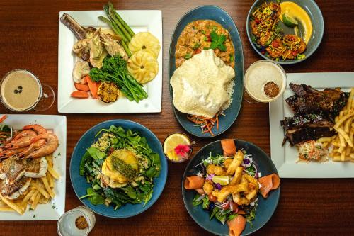 a wooden table with plates of food on it at Yandina Hotel in Yandina
