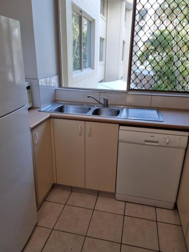 a kitchen with a sink and a window at Santa Monica Apartments - Hosted by Burleigh Letting in Gold Coast